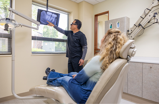 Emergency dentist showing a patient x rays of their teeth