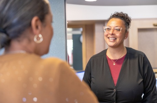 Dental team member smiling at Lorain dental patient