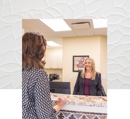 Lorain dental team member at front desk smiling at a patient