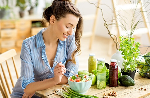 Smiling woman about to eat a salad