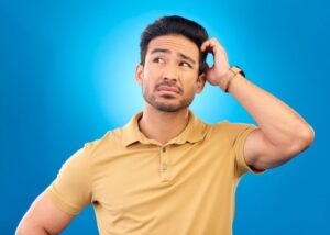 Confused man scratching his head