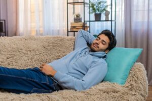 Man relaxing on his sofa at home after an apicoectomy 